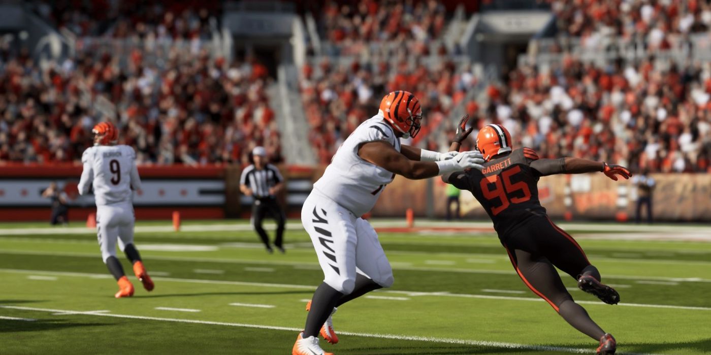 Browns lineman Miles Garrett in Madden NFL 24, trying to get out of a block to sack Bengals quarterback Joe Burrow, who is stepping back to throw. A referee and the crowd are blurred in the background.