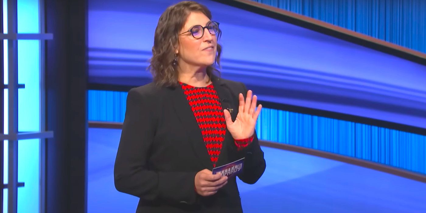 Mayim Bialik talking to a contestant while hosting an episode of Jeopardy