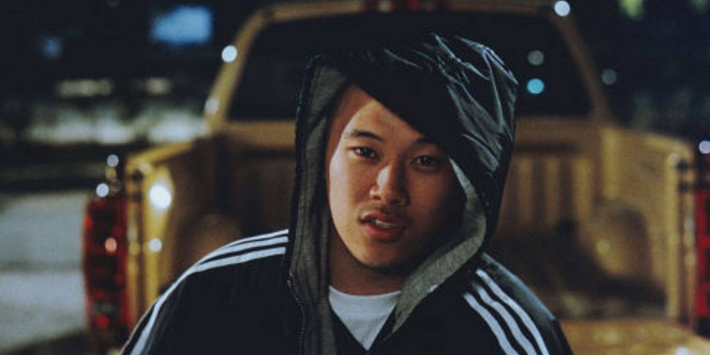 MC Jin standing in front of a pickup truck in 2 Fast 2 Furious