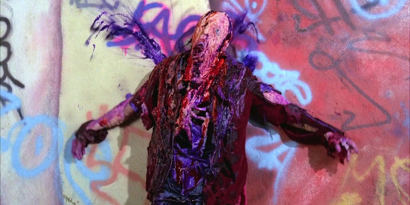A body is melted down to bones and skin with purple goo spewing out of the shoulder.