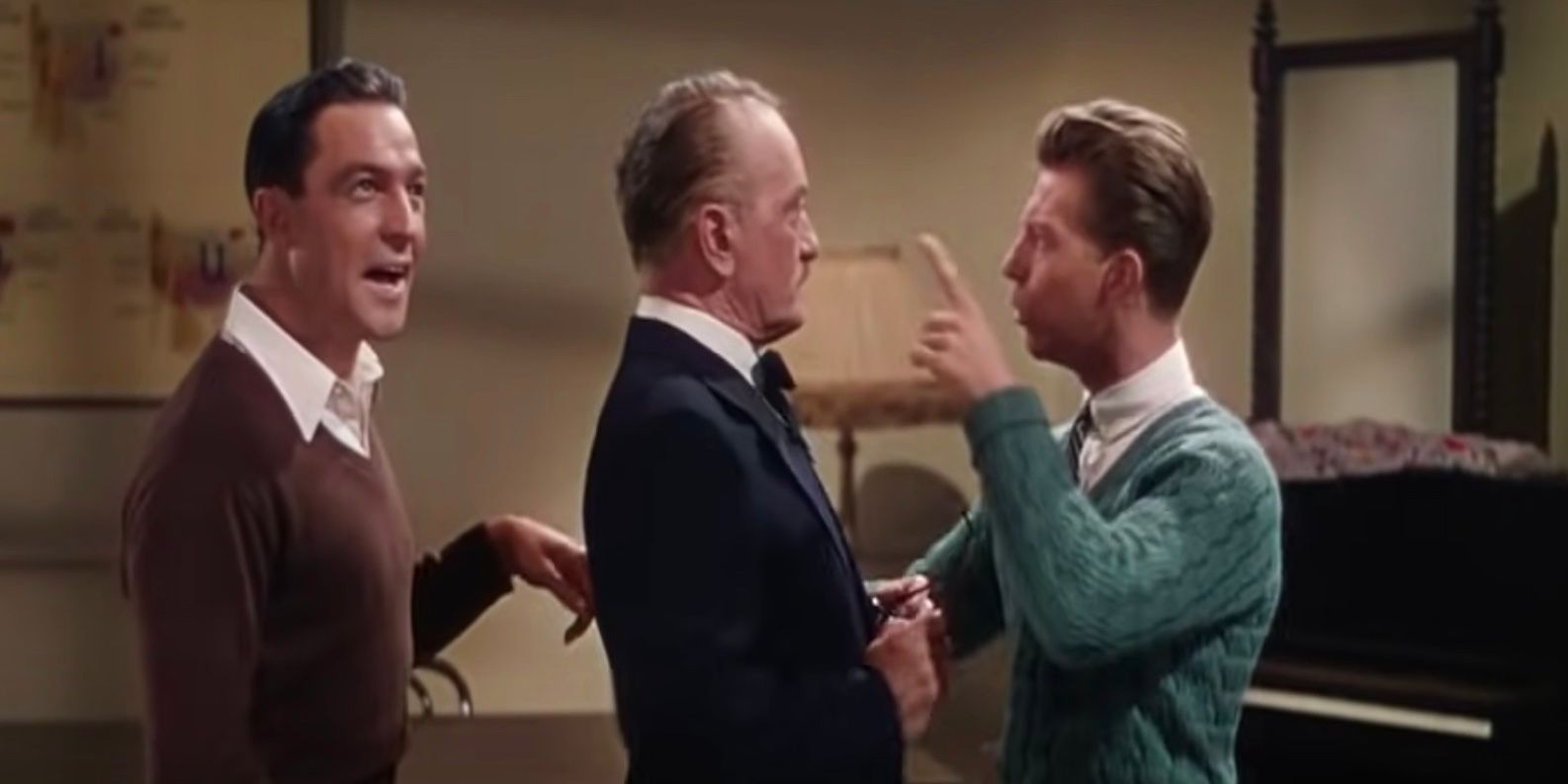 Three men talking to each other in Singin' In The Rain
