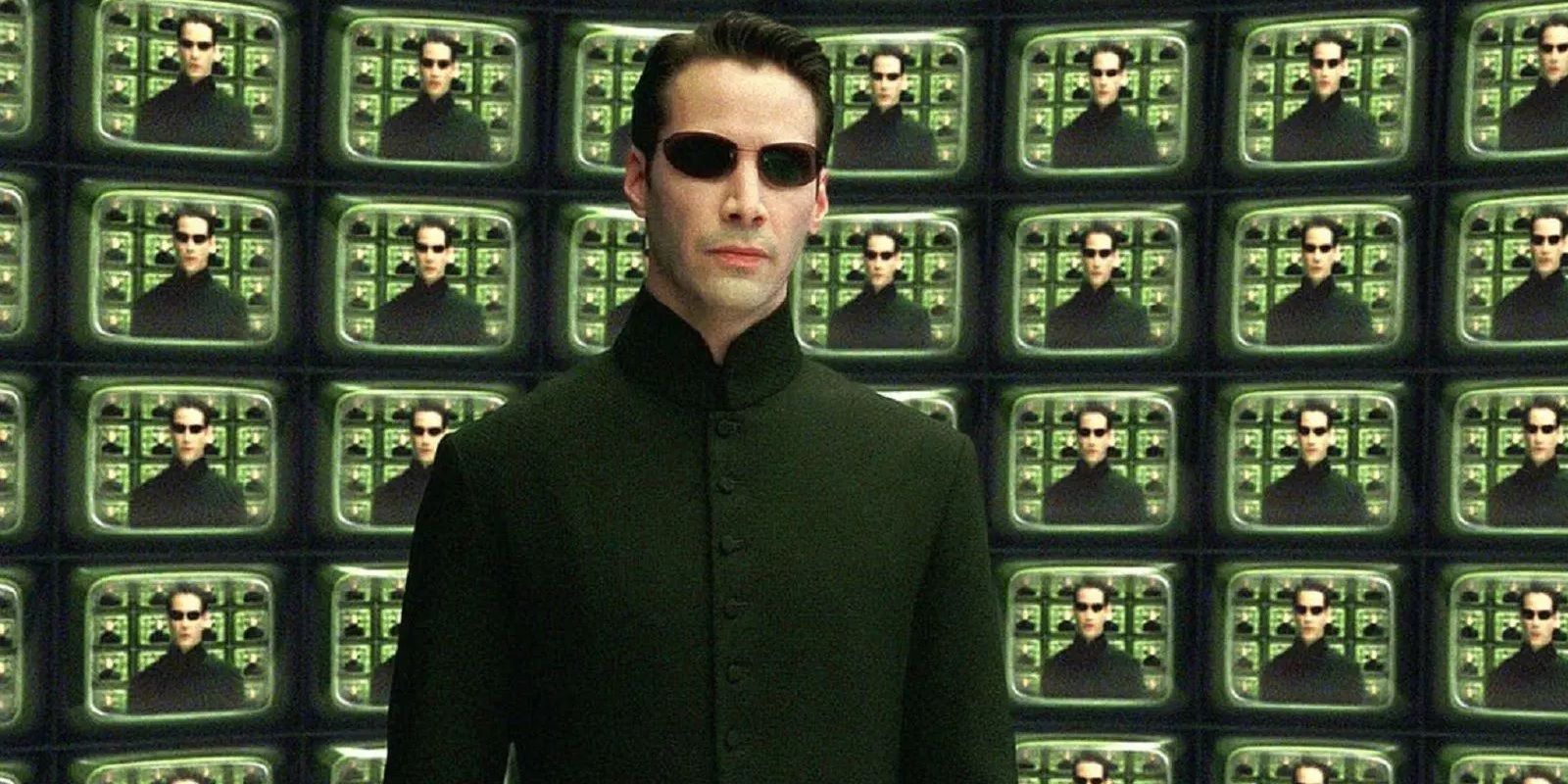 Neo speaks to the Architect in front of screens in The Matrix Reloaded