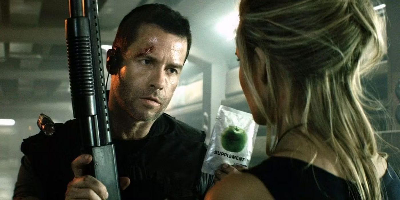 Guy Pearce holding a gun in Lockout