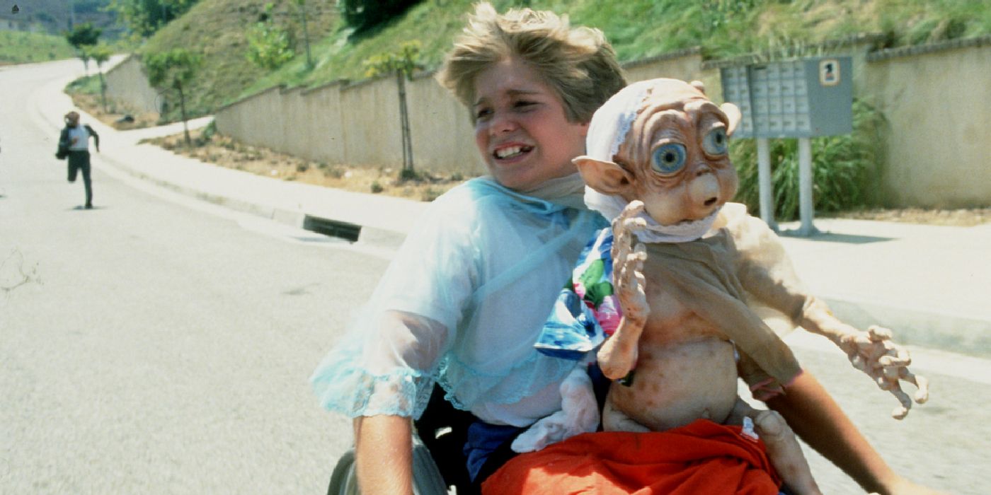 A boy holding Mac in Mac and Me