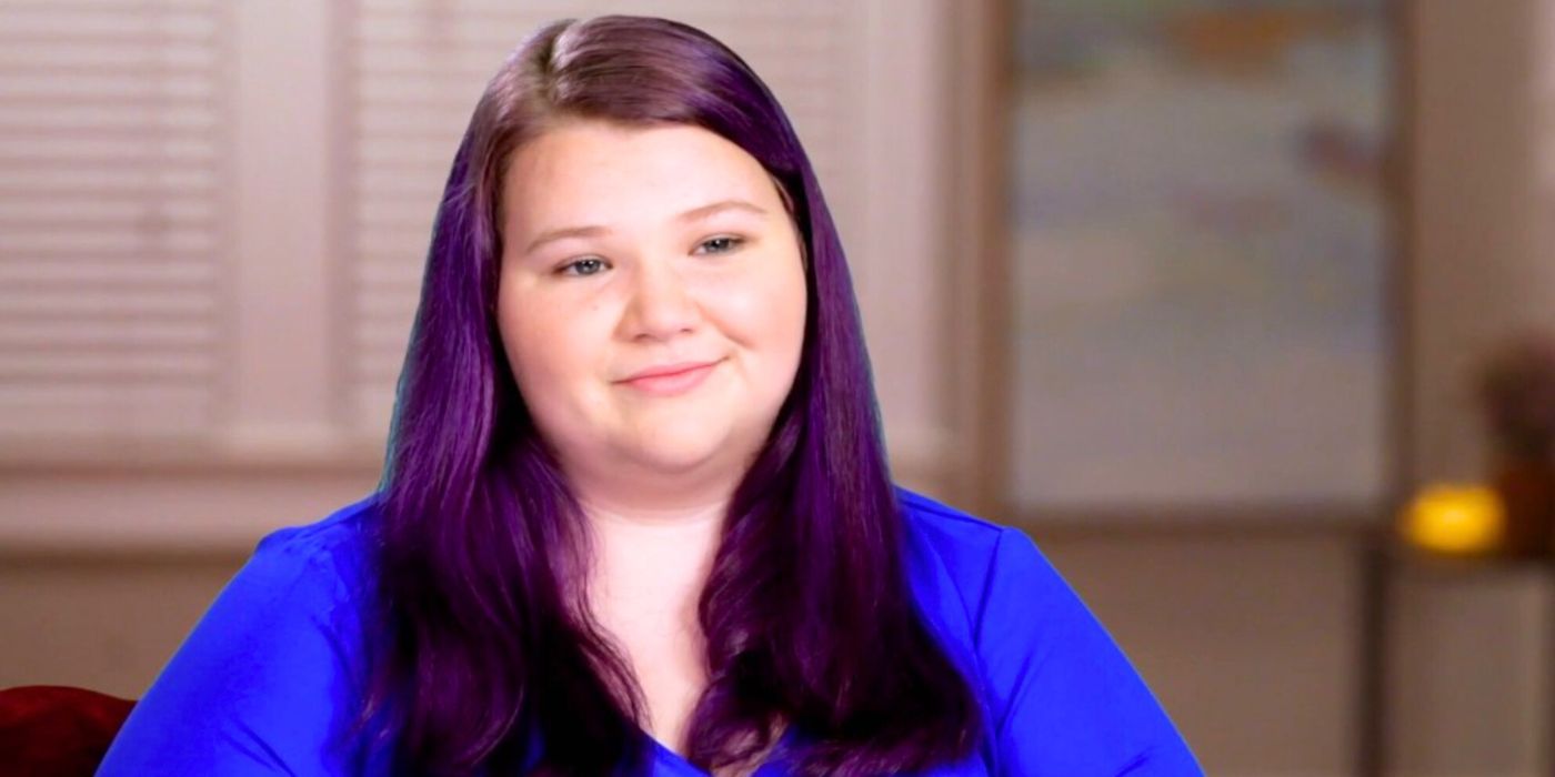 Nicole Nafziger from 90 Day Fiance in blue top with purple hair smiling