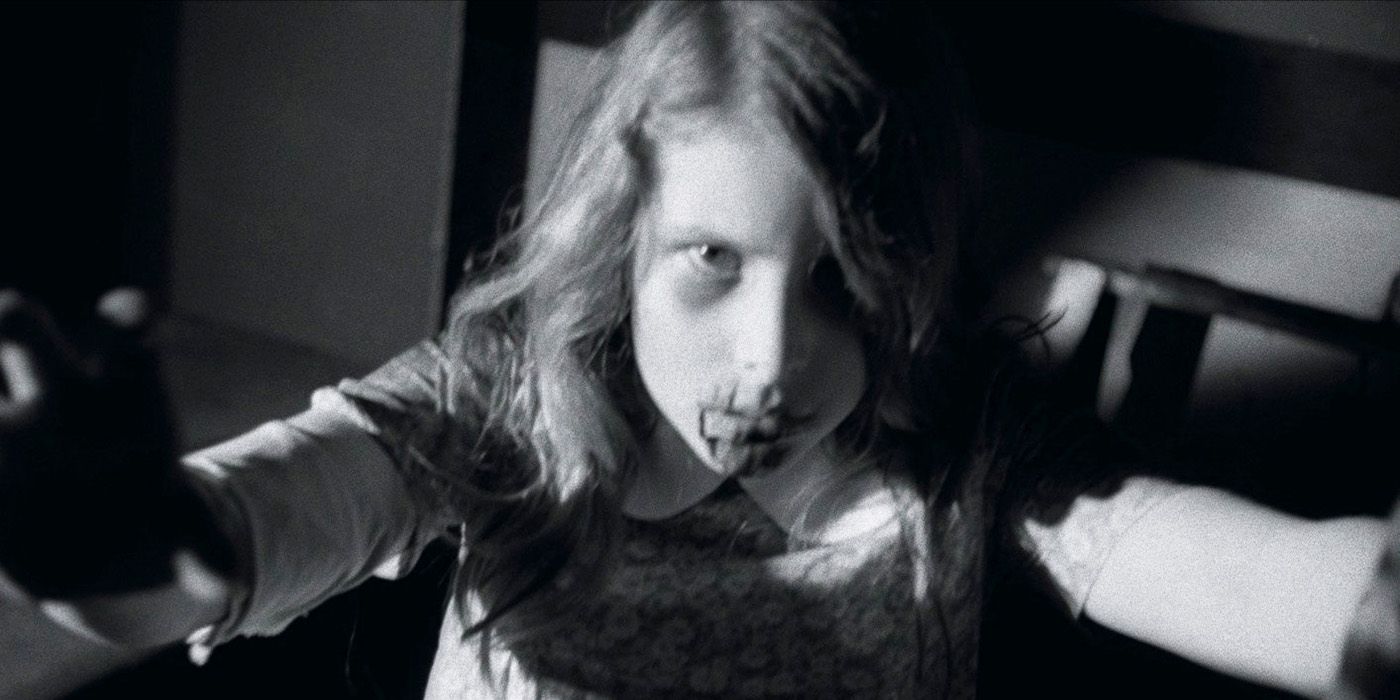 A zombie girl lunges toward the camera in Night of the Living Dead