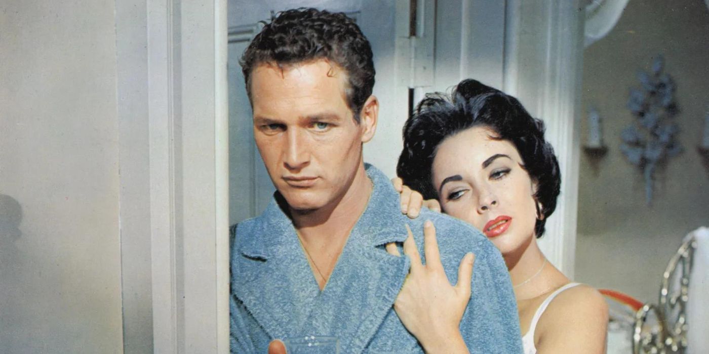 Paul Newman as Brick looking serious while Elizabeth Taylor as Maggie holds him lovingly in Cat on a Hot Tin Roof.