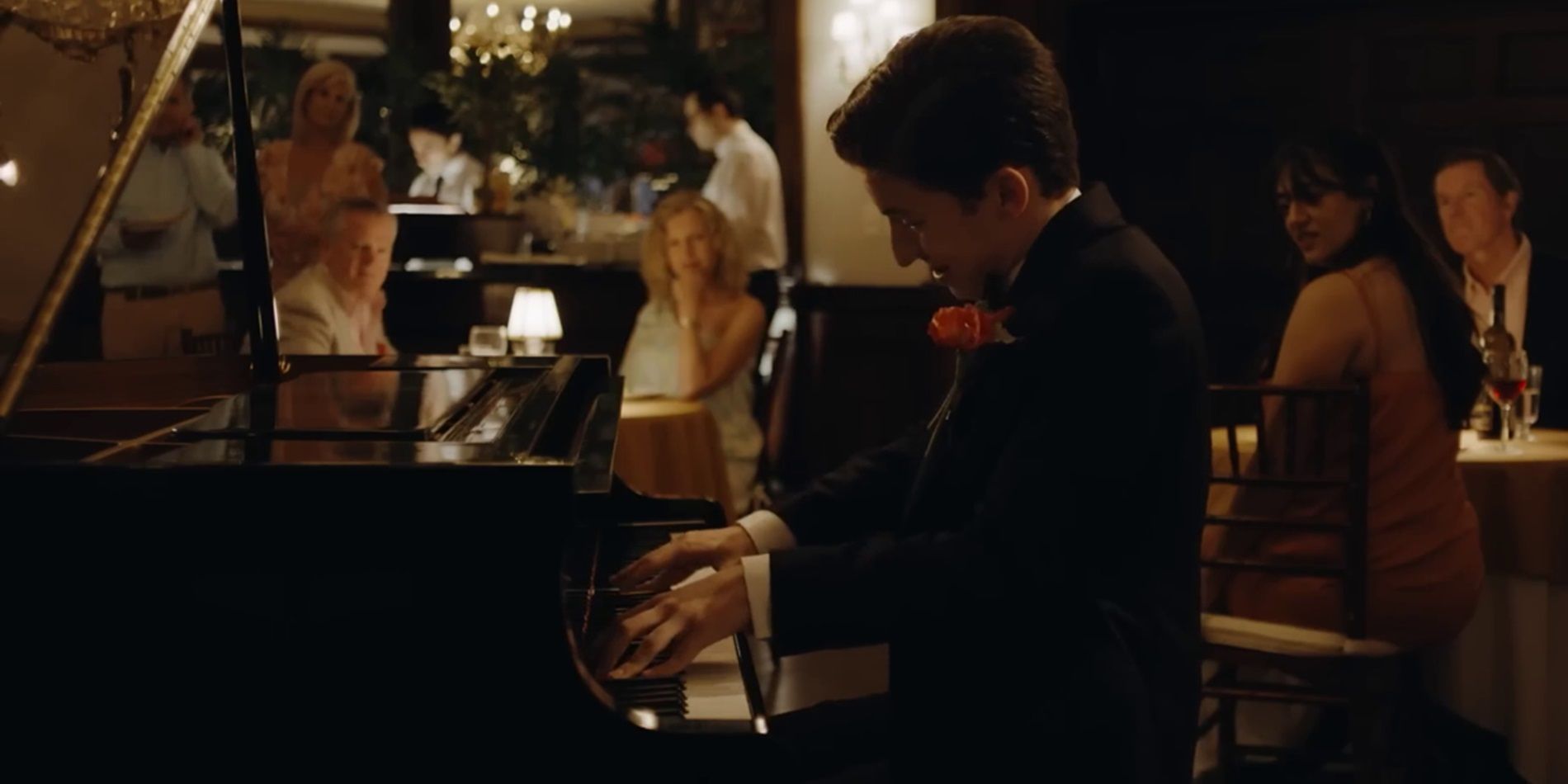 Percy plays the piano in a restaurant in No Hard Feelings