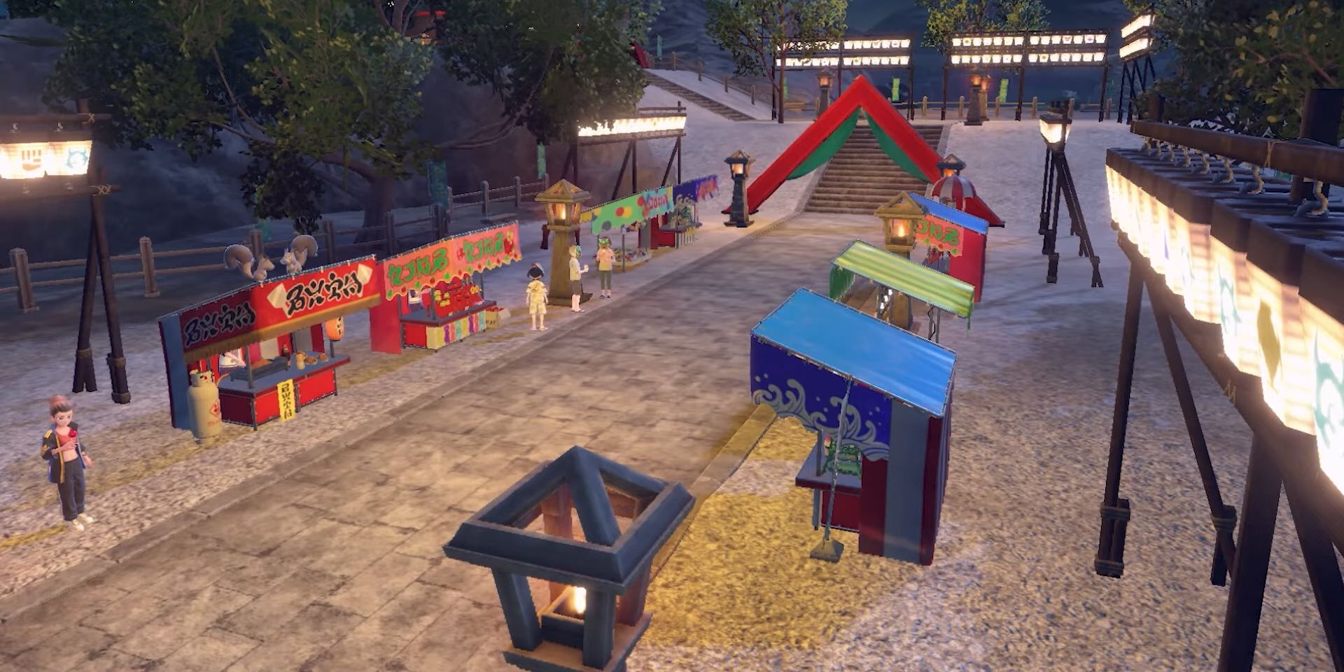 A variety of colorful stands line a paved road in a screenshot from Pokemon&rsquo;s Teal Mask DLC. The road leads to a red, triangular gate, and beyond, a shrine.