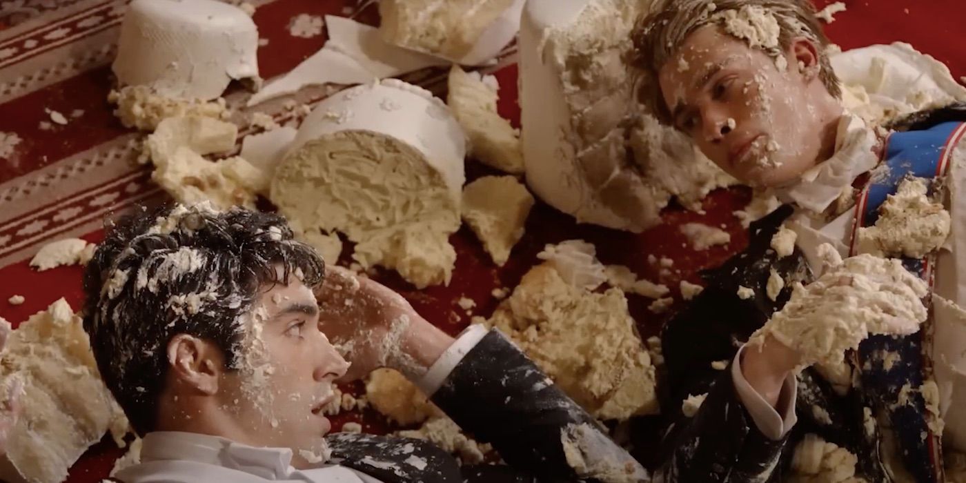 Prince Henry and Alex covered in cake in Red, White &amp; Royal Blue.