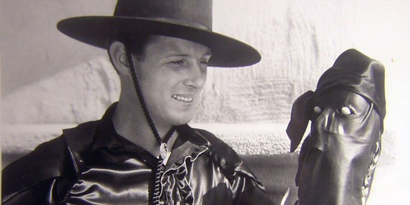 Robert Livingston holding a Zorro mask in The Bold Caballero