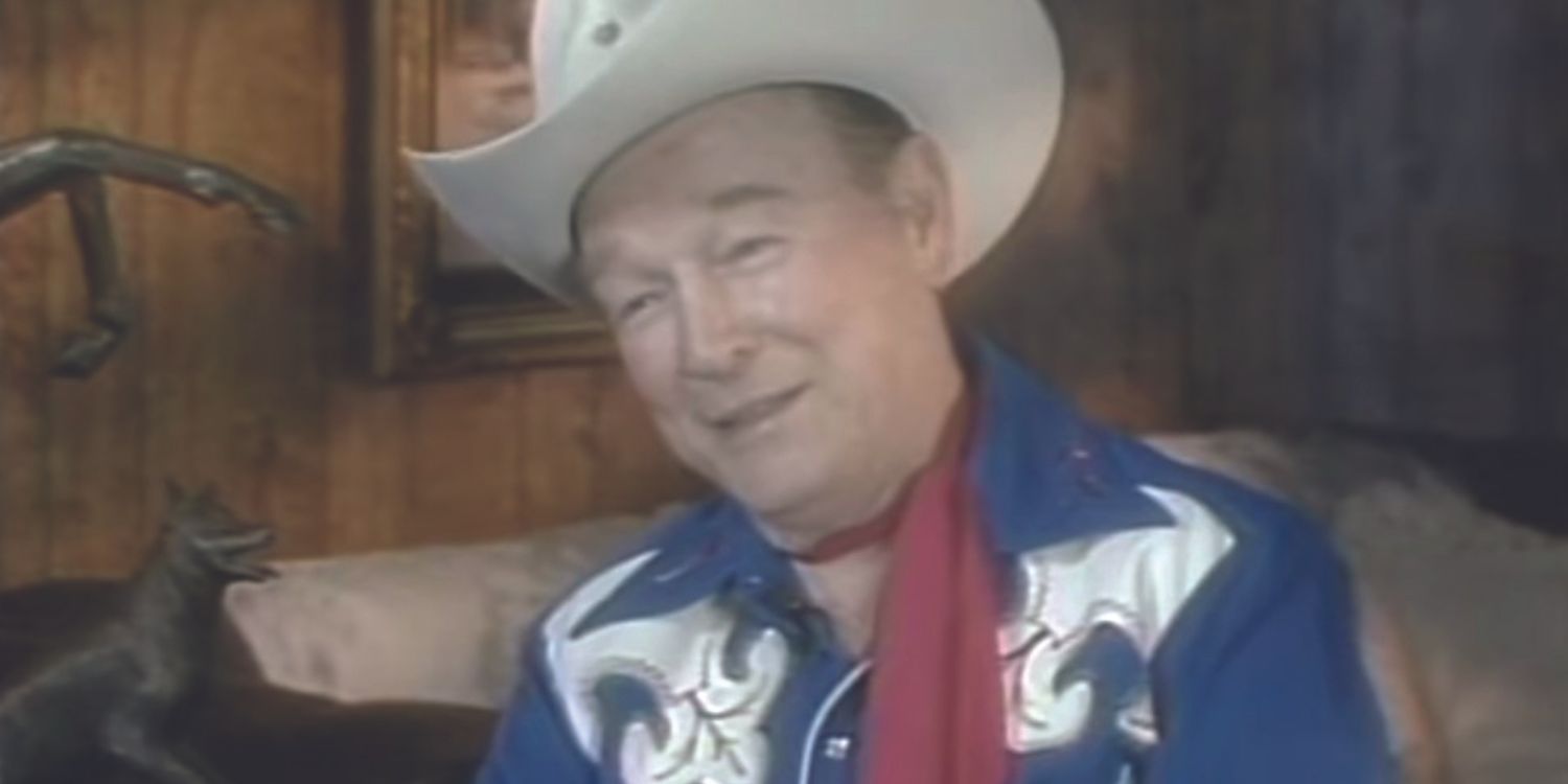 Medium closeup of actor and singer Roy Rogers wearing a blue cowboy outfit.