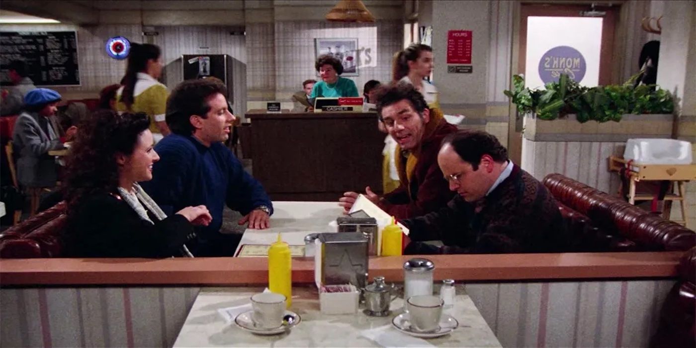The main four cast member sitting at Monks in Seinfeld