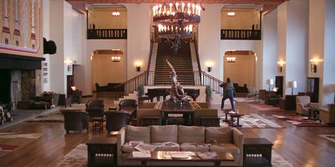 Jack Torrance (Jack Nicholson) running through the main hall of the Overlook Hotel in The Shining.