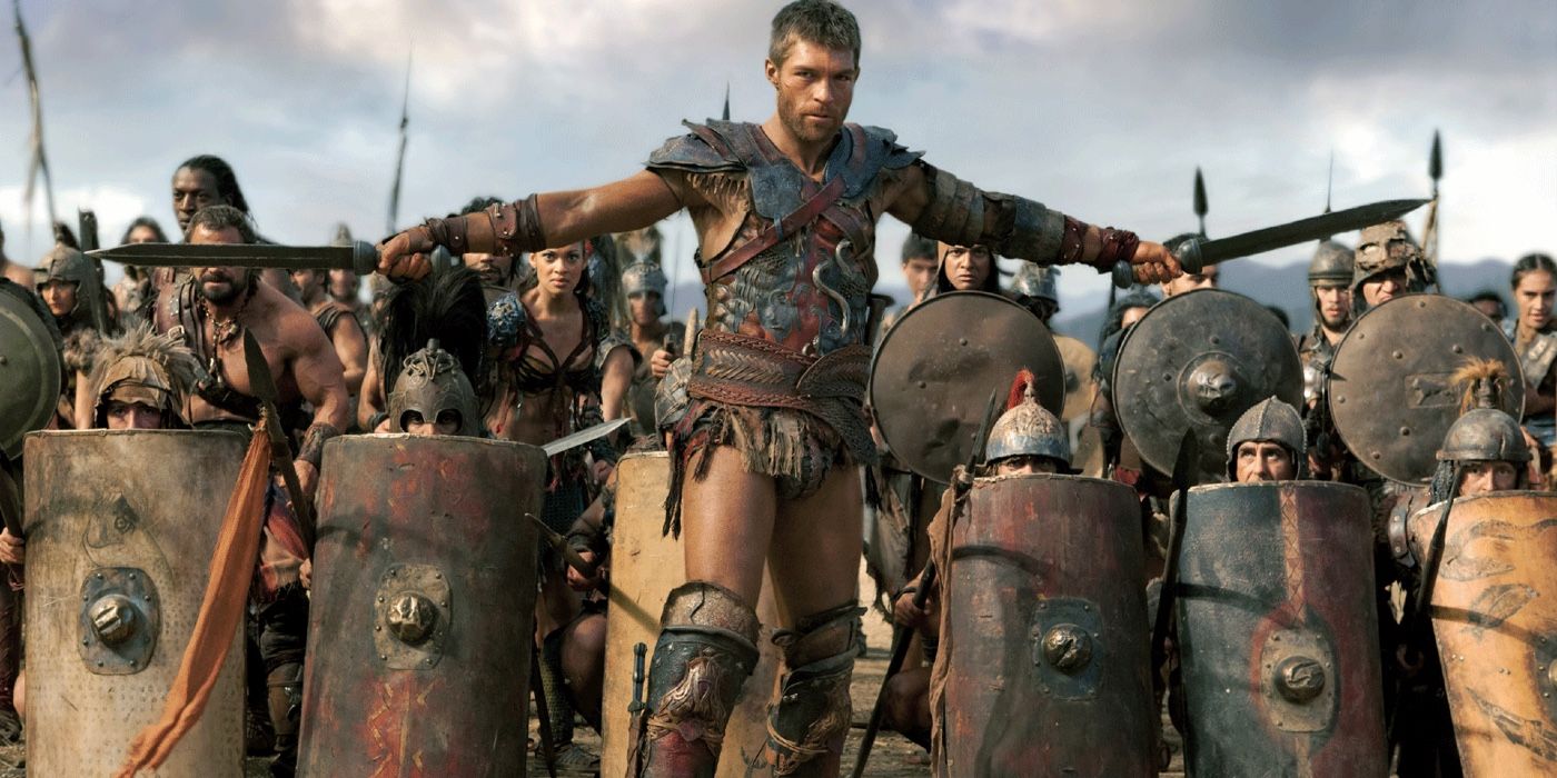 Spartacus holding two swords in front of his army in Spartacus