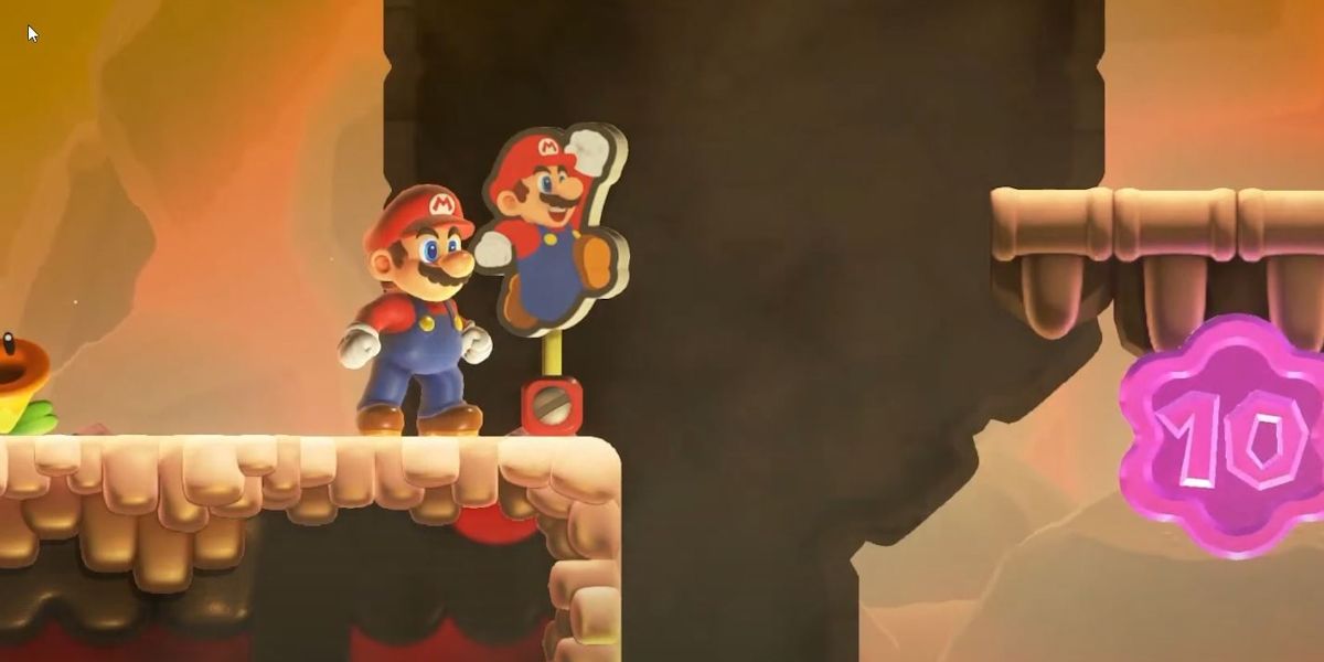Mario standing next to a Mario Standee In Super Mario Bros Wonder