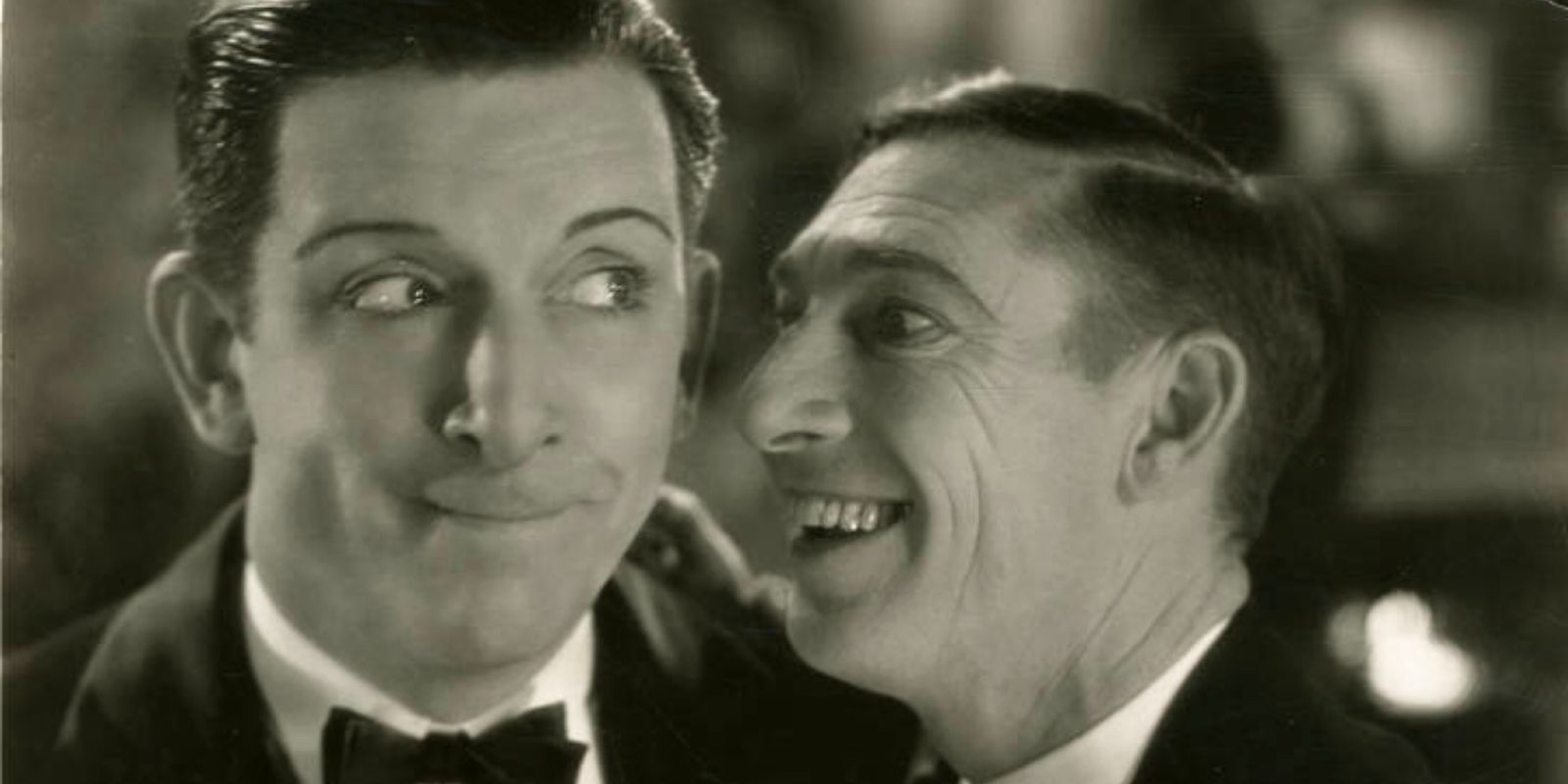 Brooks smiles and laughs next to Robert Street in The Aviator.