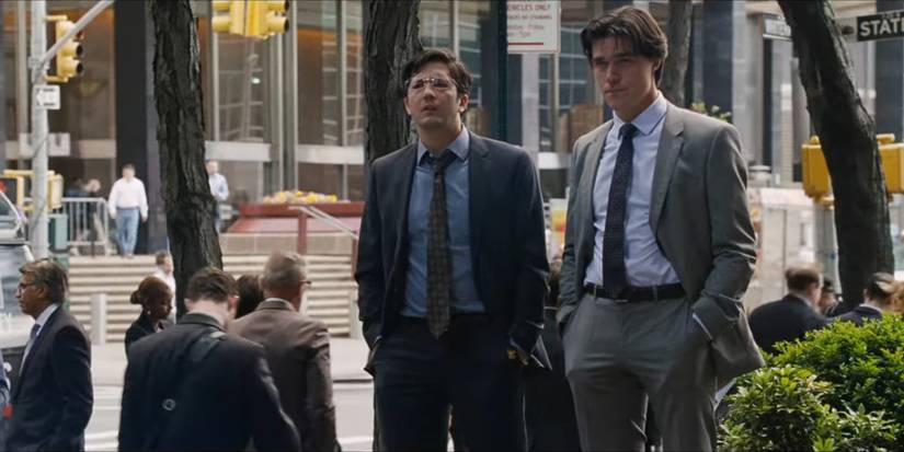 Jamie (Finn Wittrock) and Charlie (John Magaro) dressed in suits walking outdoors in the city in The Big Short