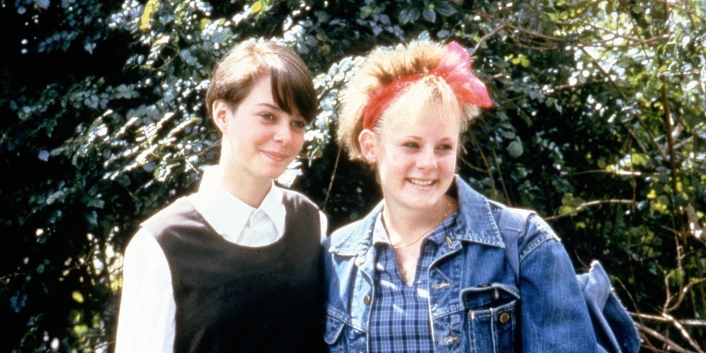 Two girls smiling and standing next to each other in 2 Friends