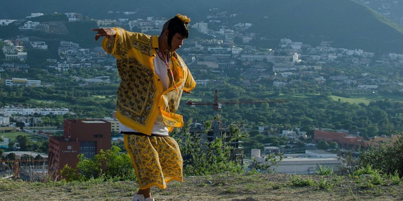 Ulisses dancing the Cumbia with a Mexican town in the backdrop in I'm No Longer Here