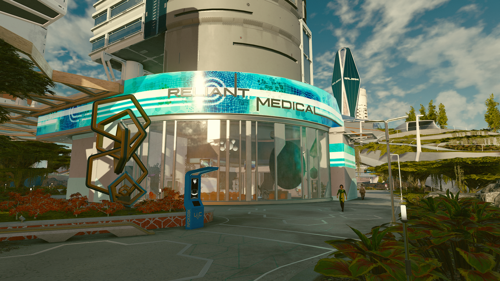 The curved silvery building of Reliant Medical, with teal and blue accents, sits on the side of a walking path surrounded by foliage and more paths in the background.