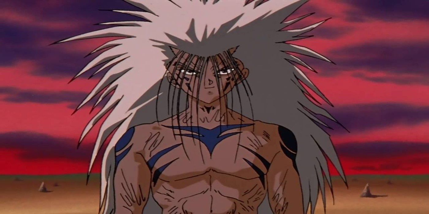 A grinning Yusuke Urameshi in demon form, with long white hair and blue markings on his shoulders and chest, in Yu Yu Hakusho.