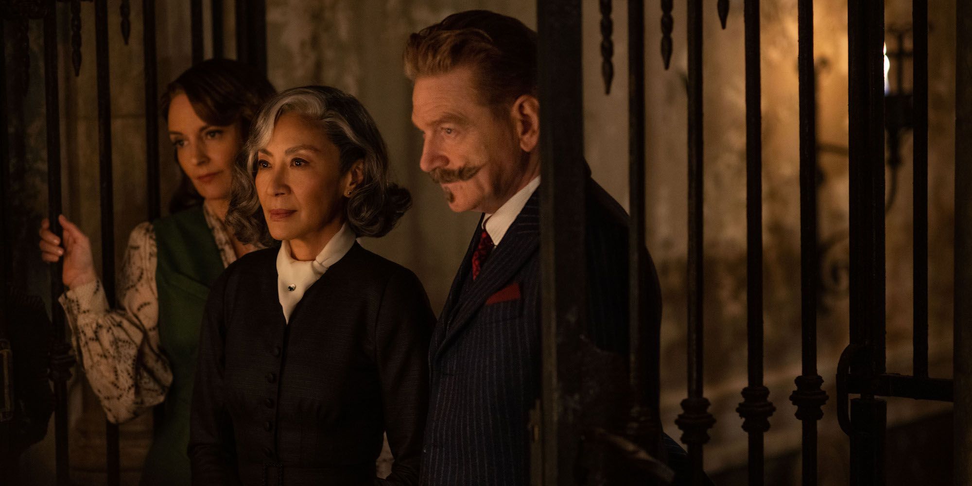 Kenneth Branagh as Hercule Poirot with Michelle Yeoh and Tina Fey in A Haunting in Venice