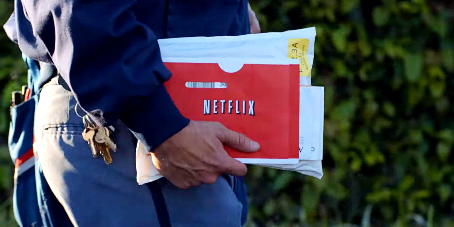 A mailman holding red envelope with the Netflix logo