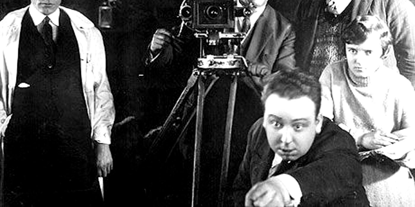 Alfred Hitchcock pointing while directing an early film