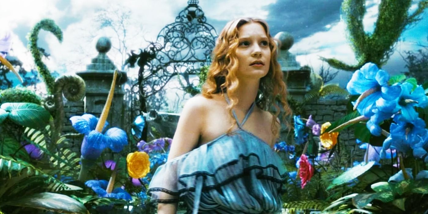 Mia Wasikowska as Alice in Alice in Wonderland surrounded by giant flowers