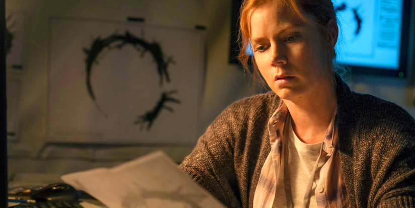 Amy Adams as Louise Banks looking at a symbol in Arrival