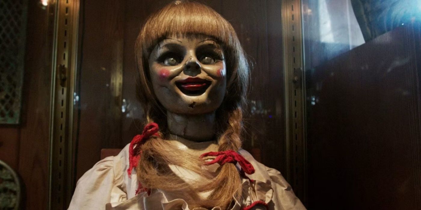 Annabelle the doll smiling in her case in The Conjuring Universe.