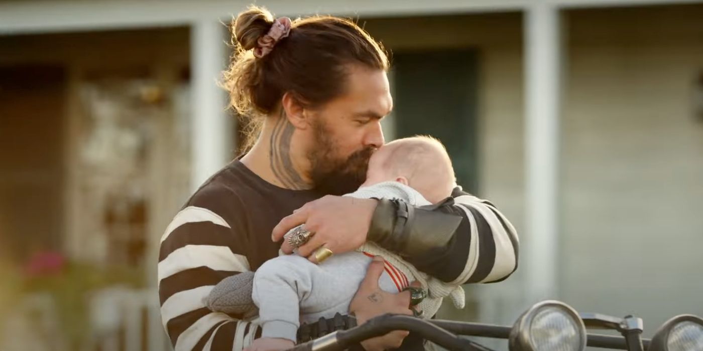 Aquaman kissing his baby on the head in Aquaman 2