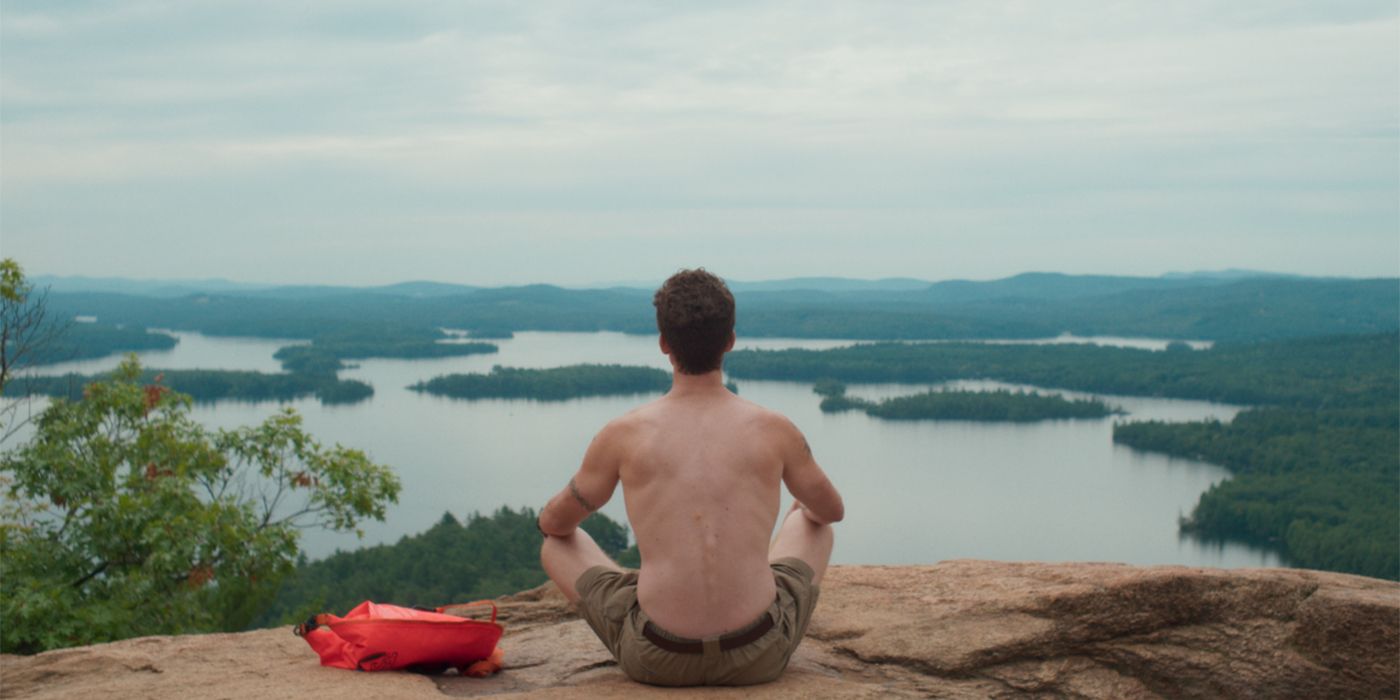 birder back of man looking at lake