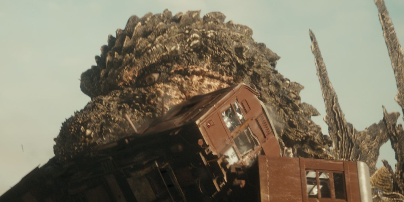 Godzilla picking up a train with his mouth in Godzilla Minus One
