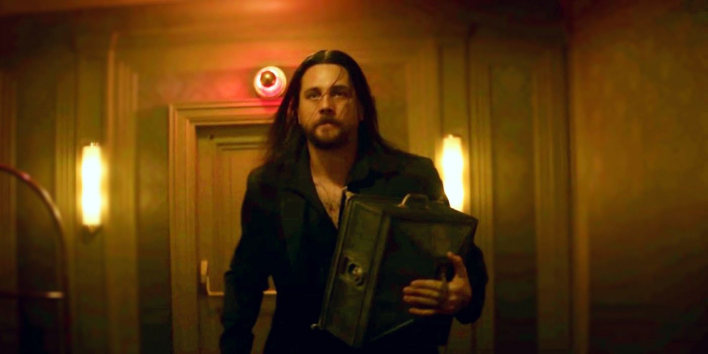 Frankie in the Continental carrying a case in the opening fight scene