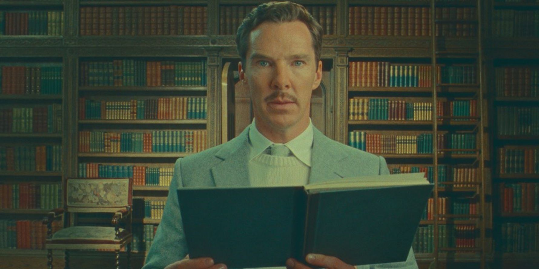 Benedict Cumberbatch as Henry reading a book in The Wonderful Story of Henry Sugar