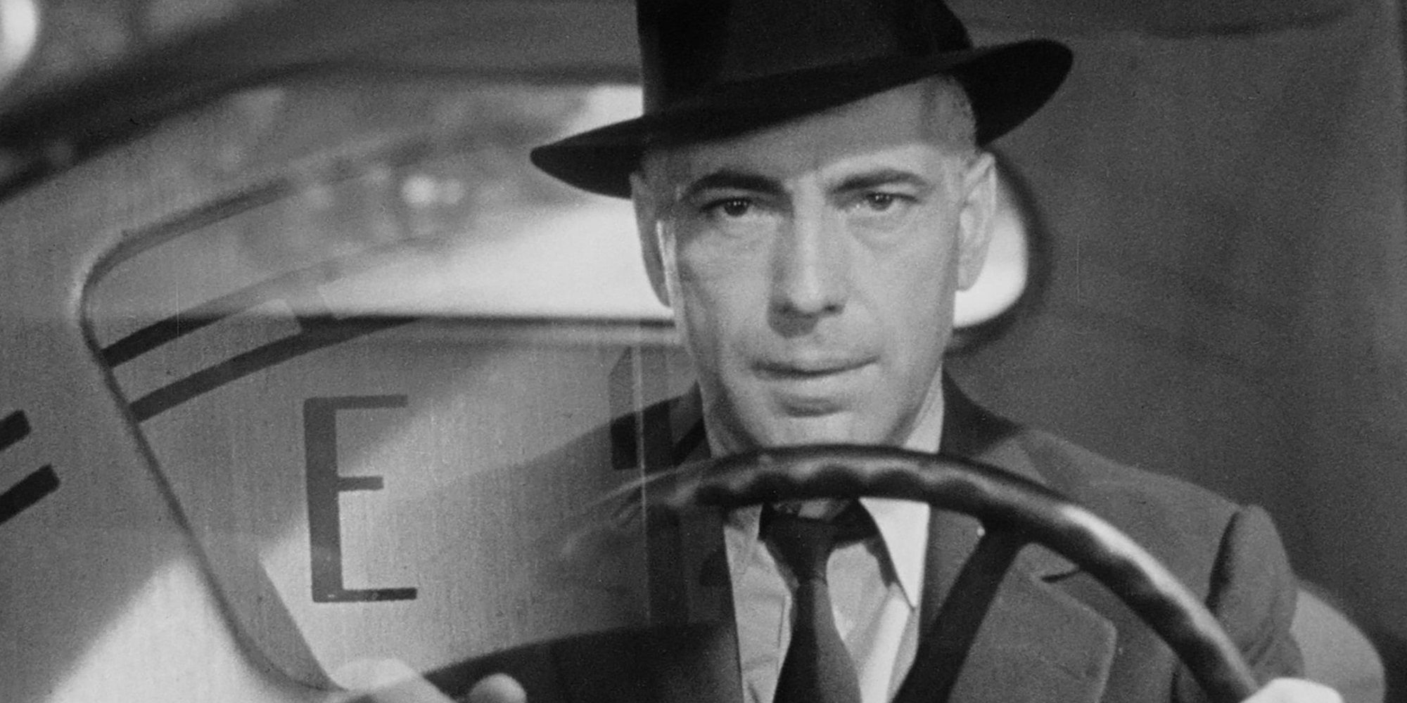 Humphrey Bogart driving a car in High Sierra