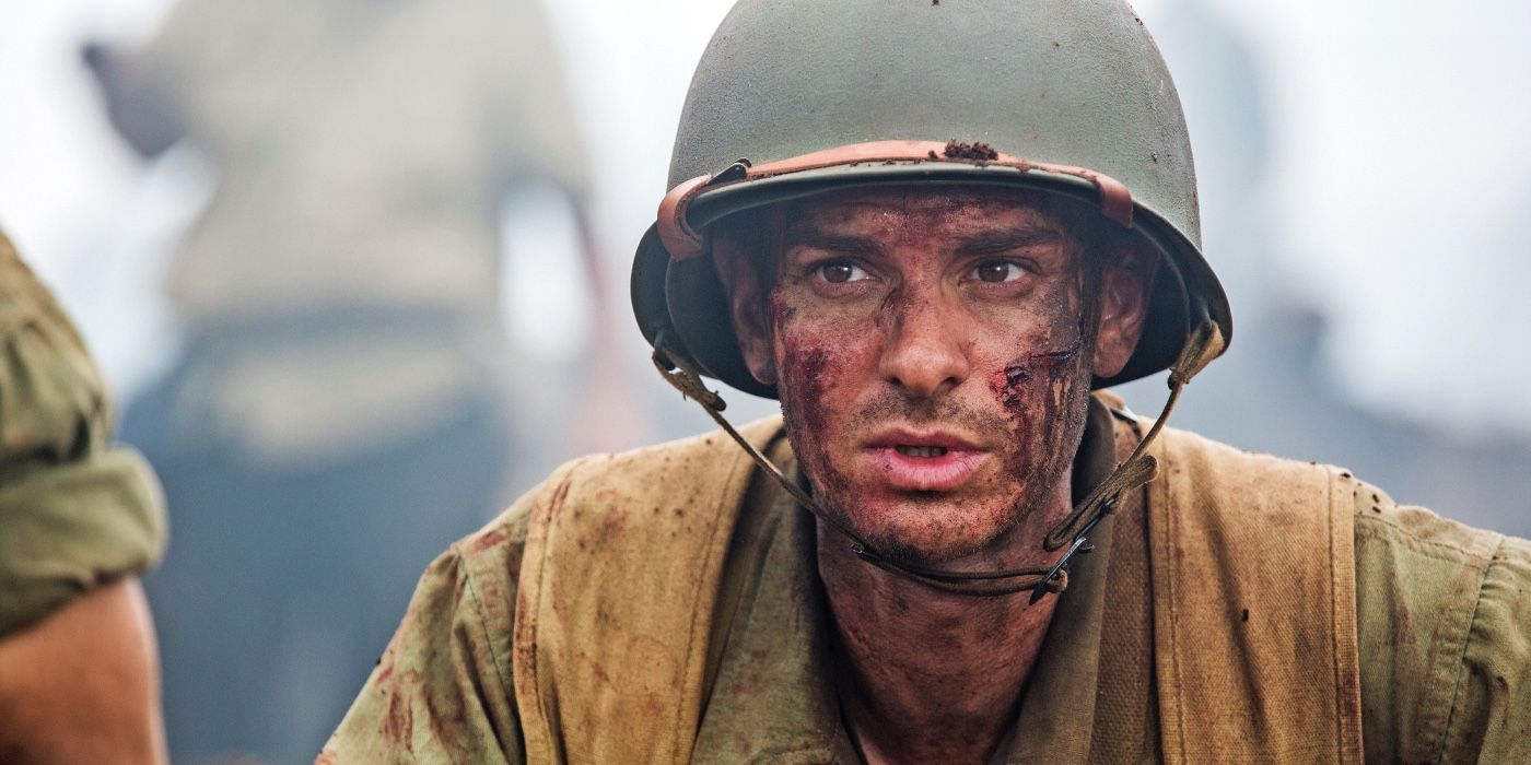 Andrew Garfield as Private Desmond T. Doss in his soldier's uniform, with dirt and blood on his face in the film Hacksaw Ridge.