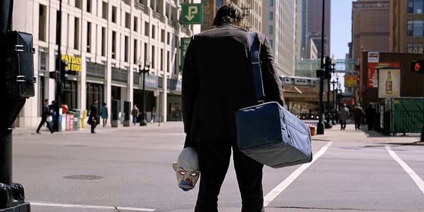 Health Ledger as The Joker stands in front of Gotham City's bank in The Dark Knight.