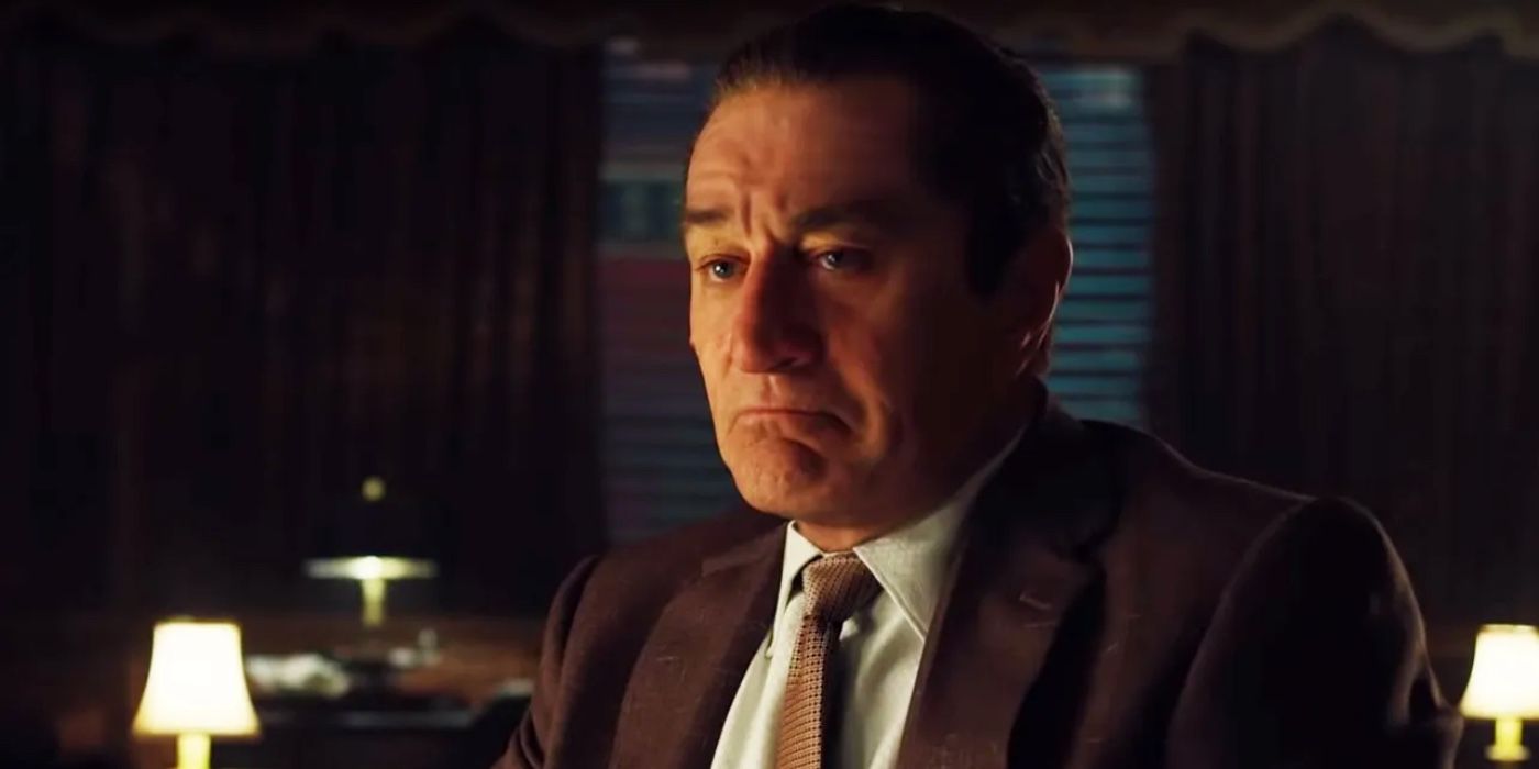 Frank Sheeran staring off, with a frown on his face in The Irishman.