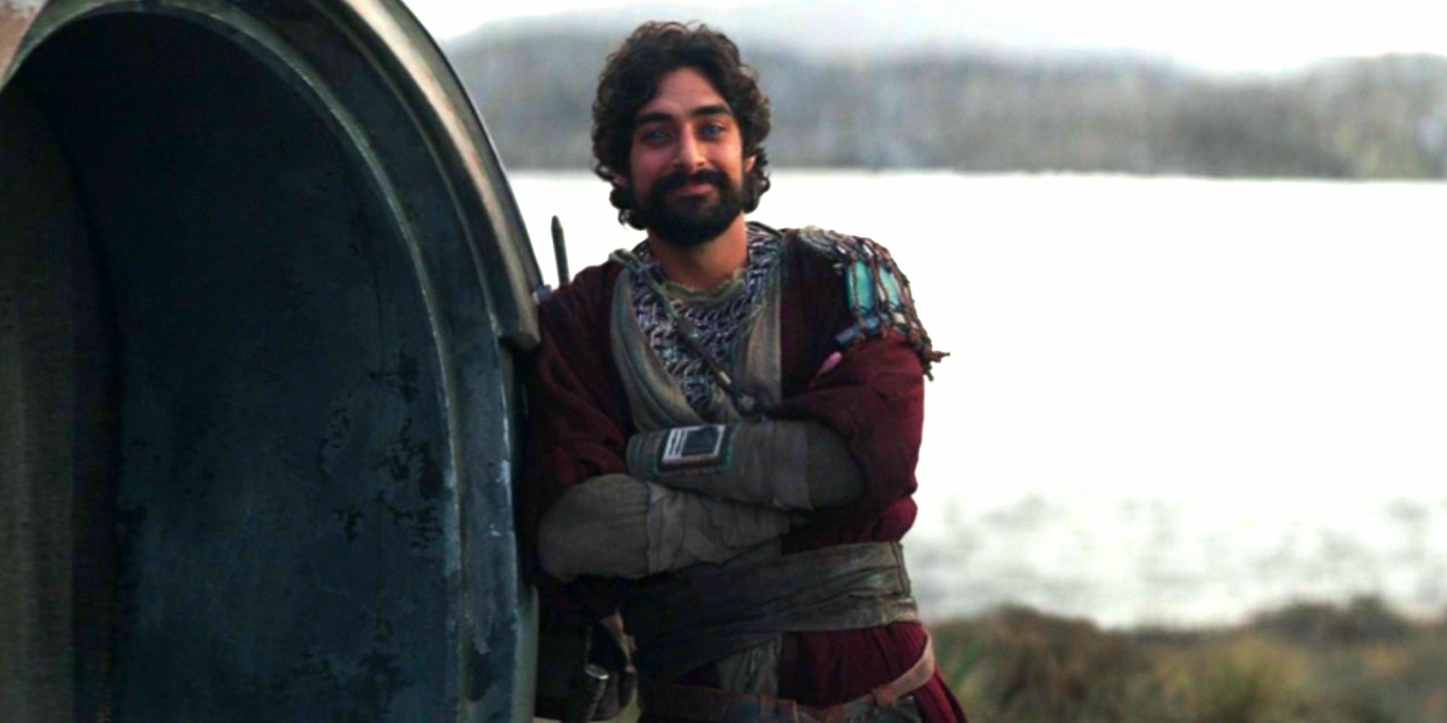 Eman Esfandi makes his debut as Ezra Bridger in Ahsoka episode 6, smiling and leaning against a doorway