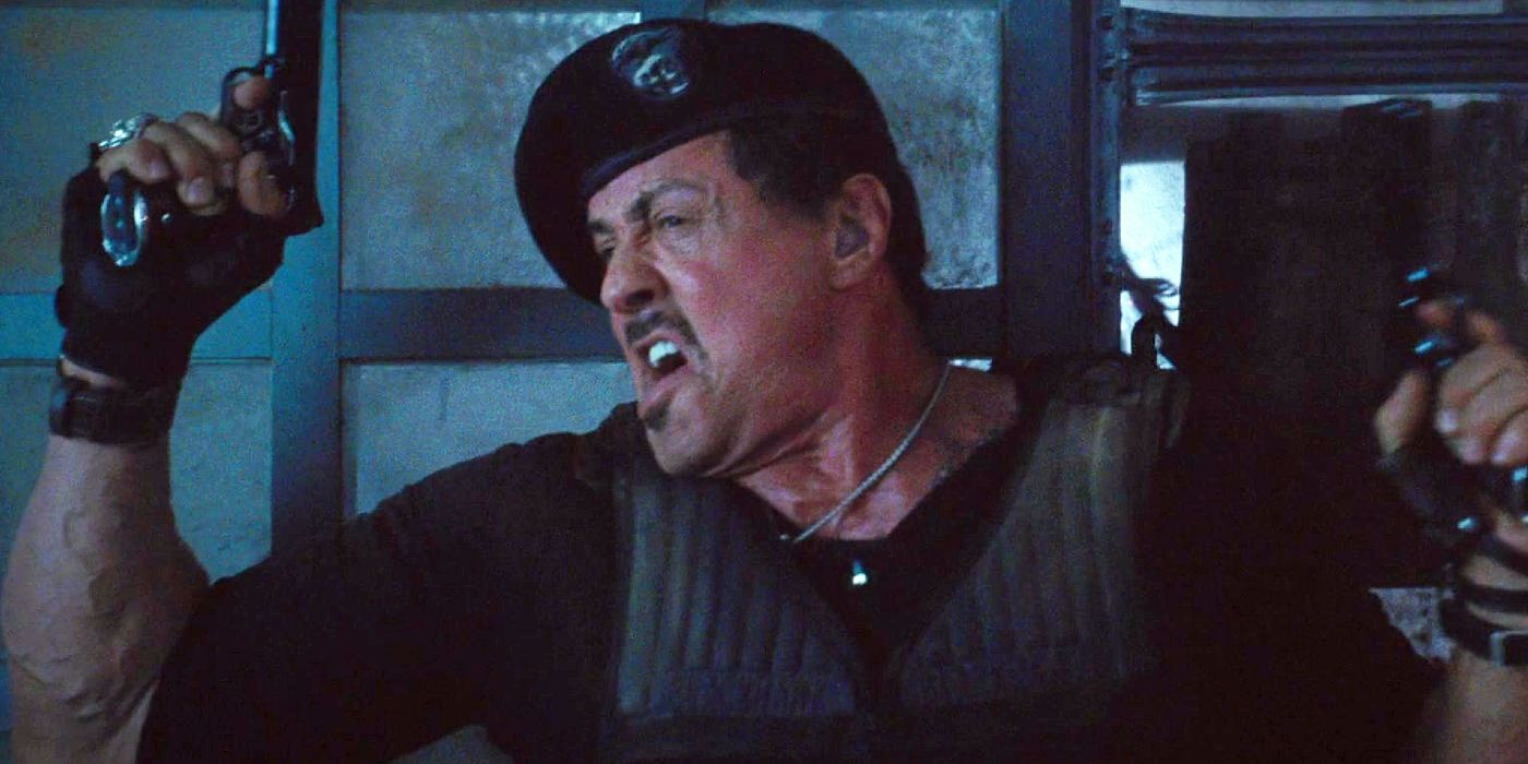 Sylvester Stallone as Barney Ross holding two guns in The Expendables 2.