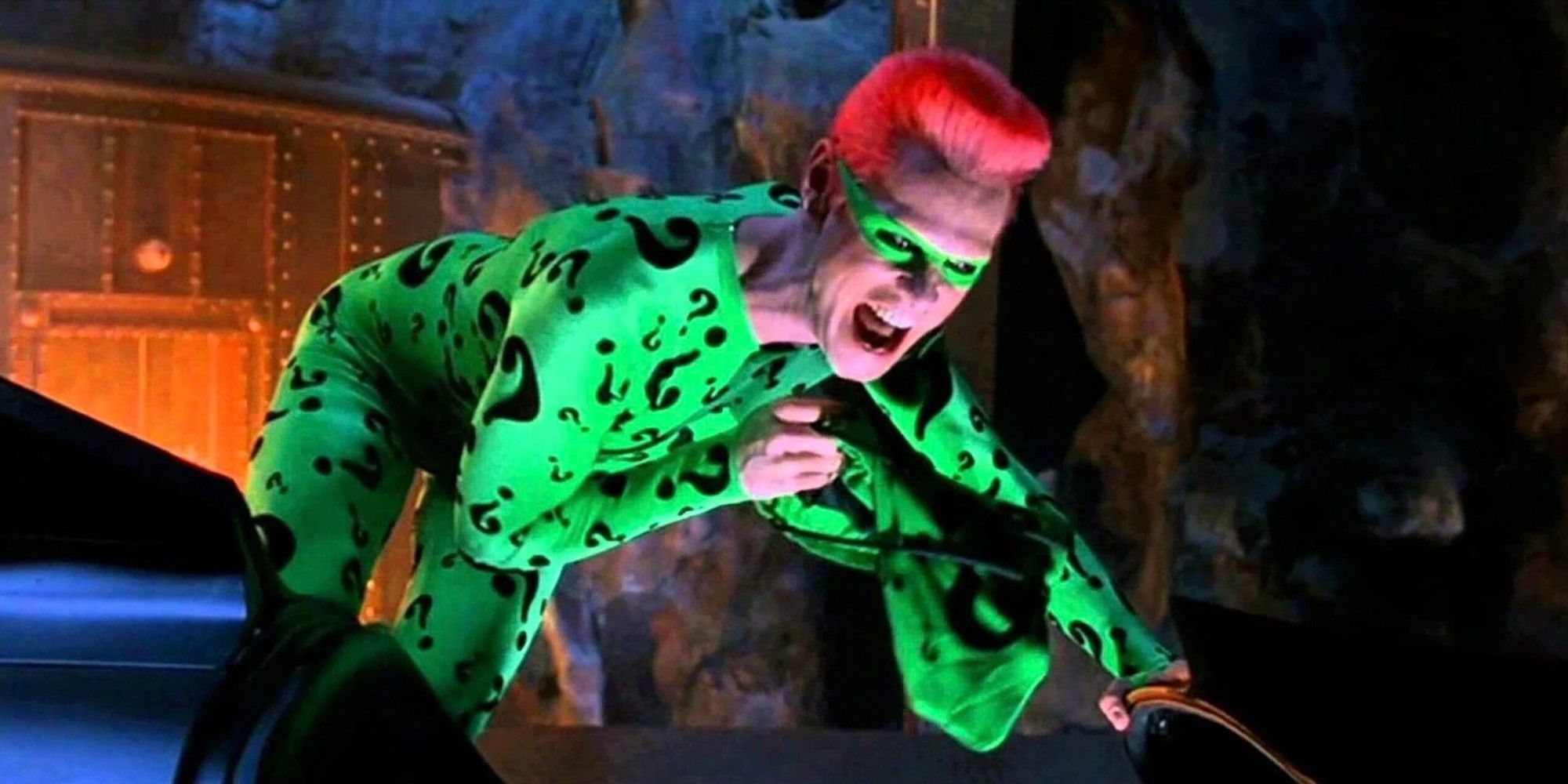 Jim Carrey's Riddler crouched and laughing in his question mark suit in Batman Forever