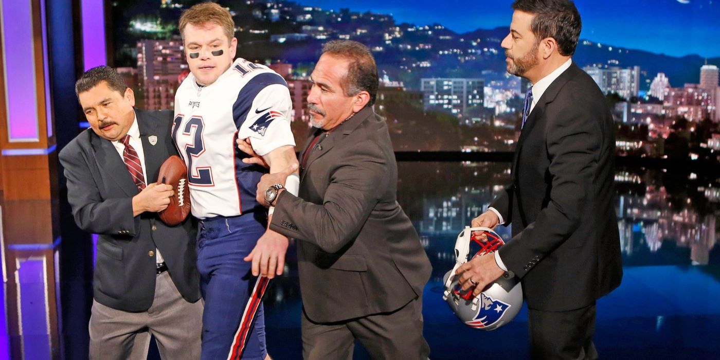 Matt Damon in a football uniform being escorted off Jimmy Kimmel Live!