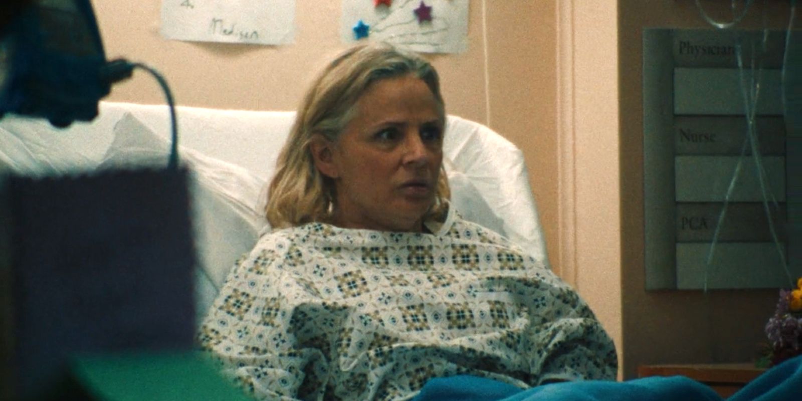 Joan sits up in her hospital bed startled.