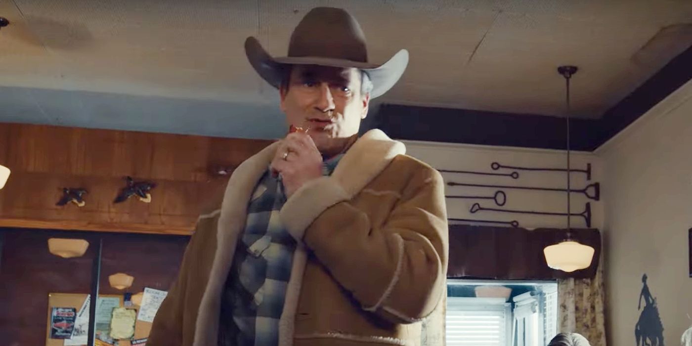 Jon Hamm eats a piece of bacon in a cowboy hat as Roy Tillman in Fargo season 5.