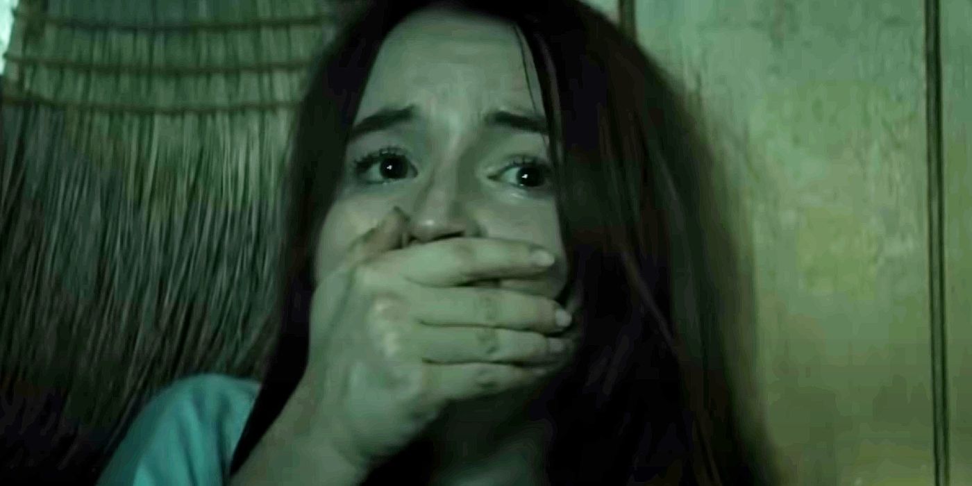 Kaitlyn Dever holding her hand over her mouth as Brynn in No One Will Save You.