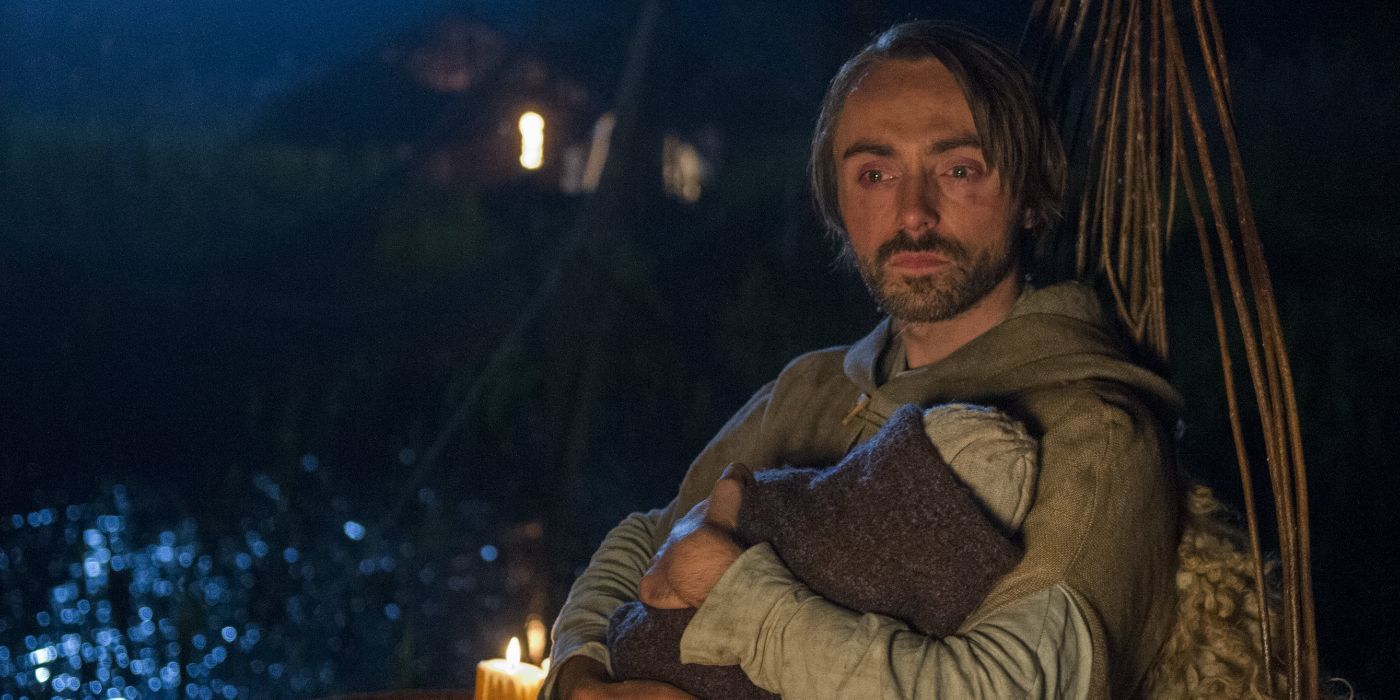 King Alfred sitting holding his baby in The Last Kingdom.