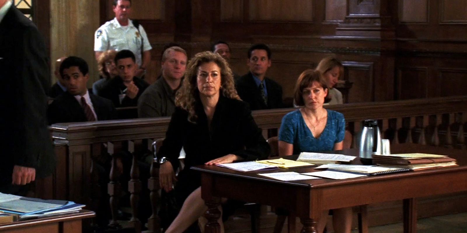 This picture shows the defense sitting at their table during a trial.
